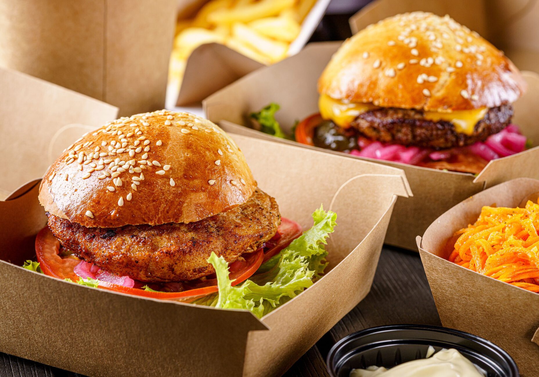 Street food. Meat cutlet burgers are in paper boxes. Food delivery. Street food. Meat cutlet burgers are in paper boxes. Food delivery.